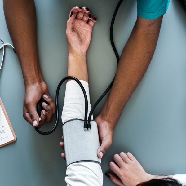 doctor taking patient's blood pressure