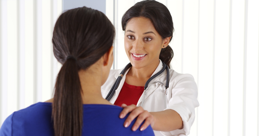 woman doctor talking to woman patient