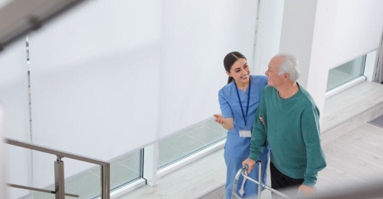 Healthcare professional helping a patient in a rehab hospital after learning about them from Harmony Healthcare