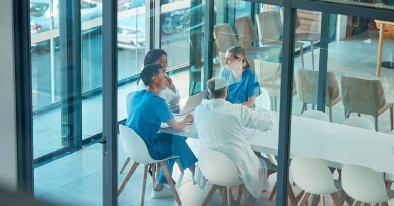 Team talking about care coordination article from Harmony Healthcare