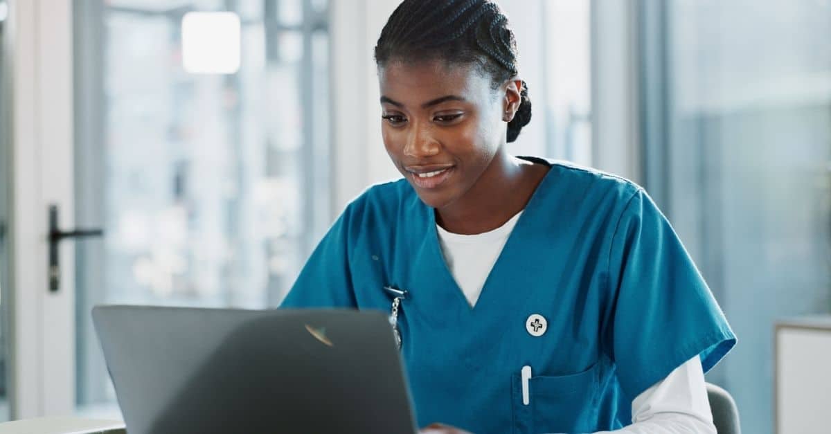 Someone sitting at computer learning about Harmony Healthcare's insights on the cost effectiveness of using contractors for non-clinical healthcare positions