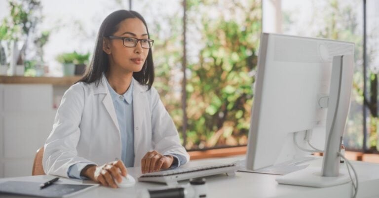 Revenue cycle professional reading Harmony Healthcare's article about revenue cycle management best practices