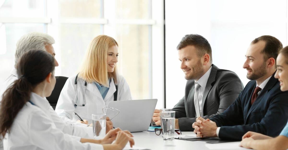 Healthcare team discussing how to navigate the cancer registry talent shortage after reading Harmony Healthcare's article