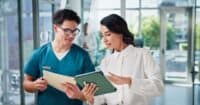 Hospital organization employees discussing if they should hire permanent or contract case managers after reading Harmony Healthcare's article